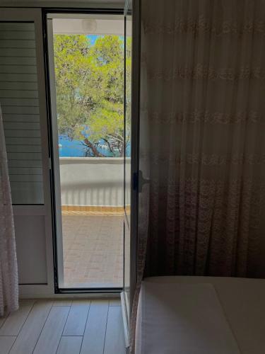 an open sliding glass door in a room with a window at Apartments Boras in Cavtat