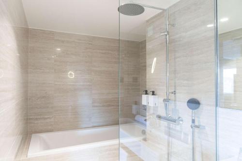 a bathroom with a shower with a glass door at Scandic Helsinki Aviacongress in Vantaa