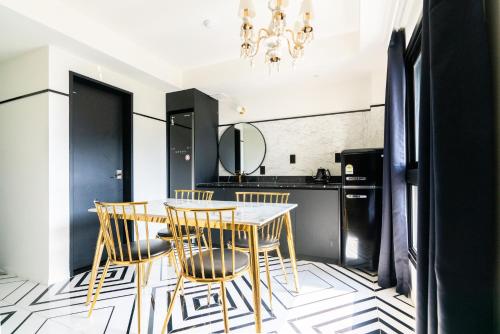 a dining room with black and white flooring and a table and chairs at Hotel Ippda Wonju in Wonju