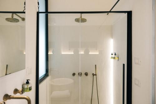 a shower with a glass door in a bathroom at Corte Manfredi in Alessano