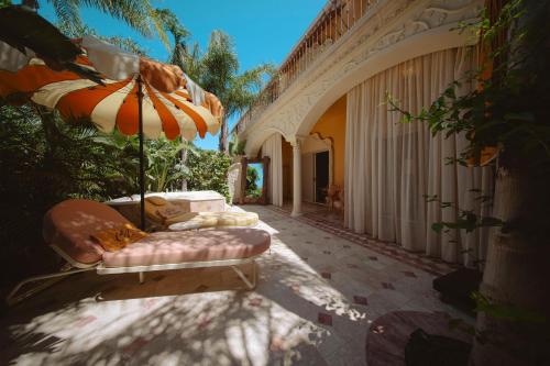 a cat laying on a couch under an umbrella at Casa Fontana in Alacati
