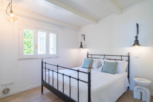 um quarto com uma cama e uma janela em Prima Luce sul Mare em Fontane Bianche