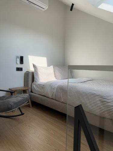 a bedroom with a bed and a chair at Mosh Mosh Boutique Hotel in Almaty