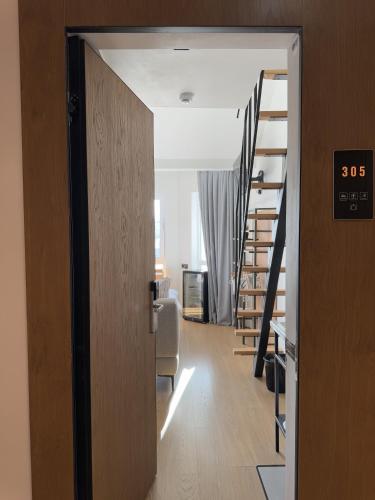 an open door to a living room with a staircase at Mosh Mosh Boutique Hotel in Almaty