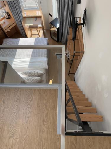 a room with a bed and a stair case at Mosh Mosh Boutique Hotel in Almaty