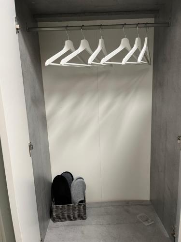 a closet with white hangers in a white wall at Kotkanlankila in Kotka