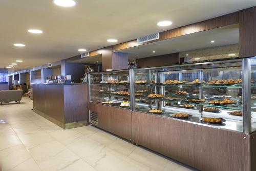 a bakery with a display case filled with food at Duja Bodrum in Torba