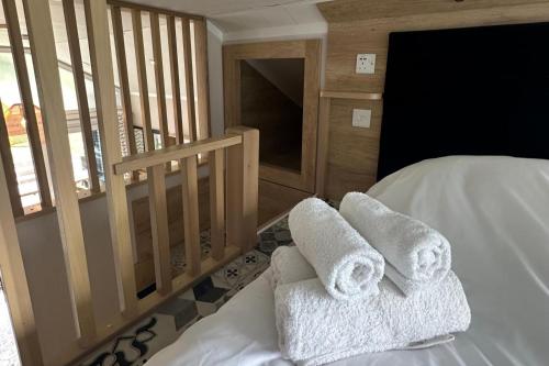 a bedroom with two towels sitting on a bed at Inverness Lodge-Sleeps 4-Parking-15 min to centre in Inverness