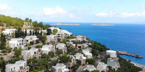 an island with white houses and the ocean at Duja Bodrum in Torba