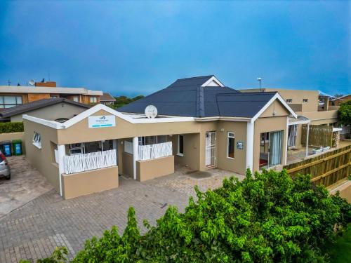 a large house with a black roof at Langebaan Stay Guest House in Langebaan
