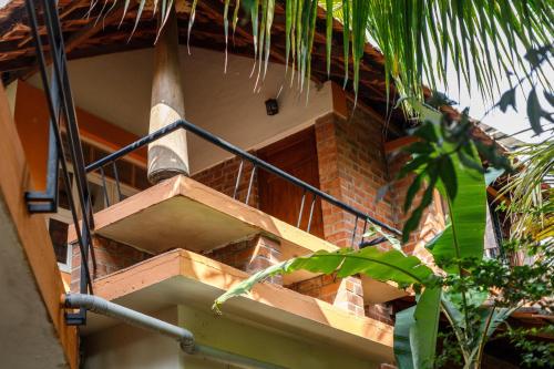 a brick building with a staircase on the side of it at Kerala Style Villa by JadeCapsAC4BHKFishpond in Yelahanka