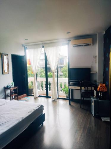 a bedroom with a bed and a large window at mstay in Bangkok