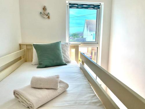 a room with a bed with a pillow and a window at 2 Bedroom Apartment with Garden, Close to Beach in Southend-on-Sea
