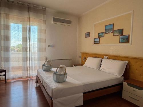 Postel nebo postele na pokoji v ubytování Albergo California