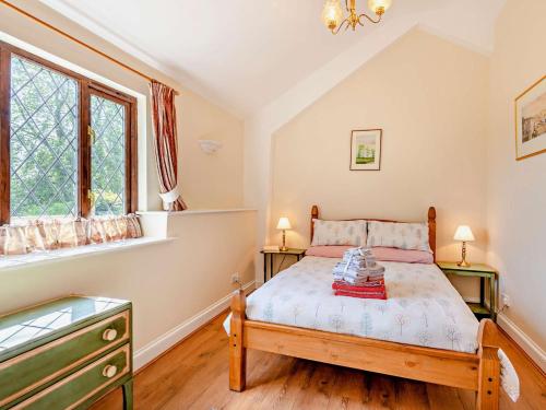 a bedroom with a bed and two windows at 1 Bed in Lamberhurst 79180 in Wadhurst