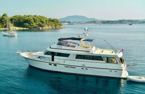 a white boat is docked in the water at Stunning Motor Yacht in Corfu in Gouvia