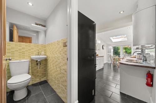 a bathroom with a toilet and a sink at Reading Station - Modern Home with its own Garden Sleeps 6 in Reading