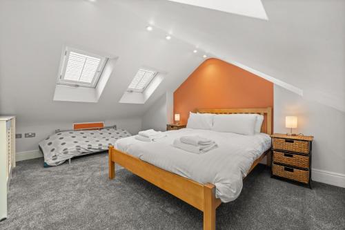 a bedroom with a large bed in a attic at Reading Station - Modern Home with its own Garden Sleeps 6 in Reading