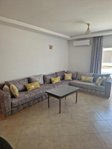 a living room with a couch and a table at appartement imi ouadar in Imi Ouaddar