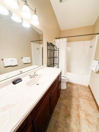 a bathroom with a sink and a large mirror at Lakefront 5BD/3BA/Dock/Firepit/Pet Friendly-17PP in Camdenton