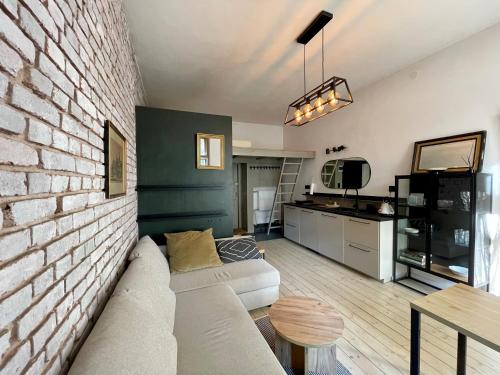 un soggiorno con un divano e un muro di mattoni di Górska Ostoja w Sokołowsku a Sokołowsko