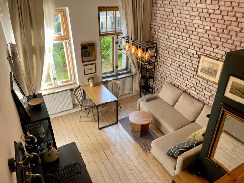un soggiorno con un divano e un muro di mattoni di Górska Ostoja w Sokołowsku a Sokołowsko