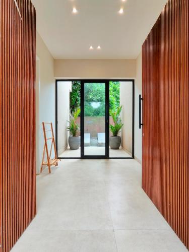an open hallway with sliding doors to a patio at Villa Takiana - 4BHK pvt pool, Gym, 5mins to beach in Anjuna