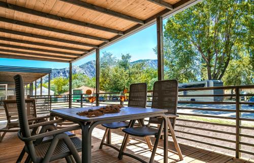 a patio with a table and chairs on a deck at Camping Almissa in Omiš
