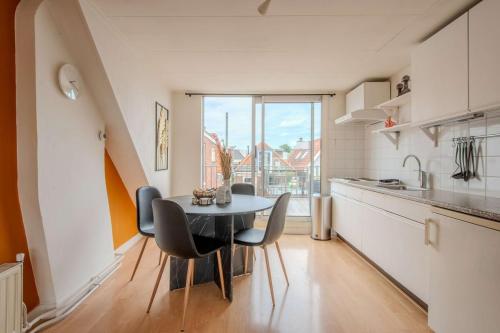 a kitchen with a table and chairs in a room at Stay de Laat in Alkmaar