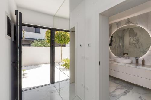 a bathroom with a sink and a mirror at Villa Verana with pool in Savudrija