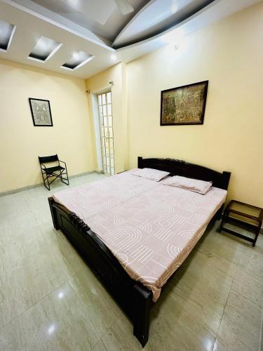 a bedroom with a large bed in a room at Family Retreat in Prayagraj