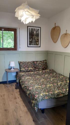 a bedroom with a bed and a table with a lamp at Pirat Turawa in Turawa