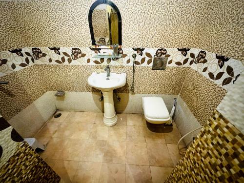 a bathroom with a sink and a toilet at Family Retreat in Prayagraj