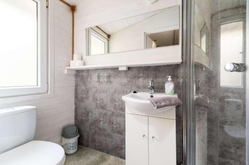 a bathroom with a sink and a mirror at Letnisko BAJKA in Iława