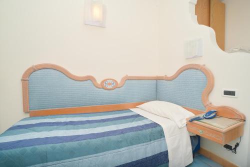 Ένα ή περισσότερα κρεβάτια σε δωμάτιο στο Albergo Italia - Beach Hotel