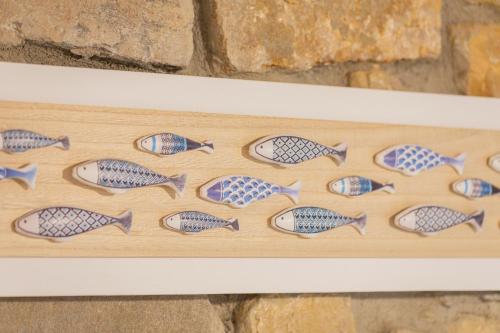 a wooden display of fish on a wall at Taosa - baskeyrentals in Zumaia