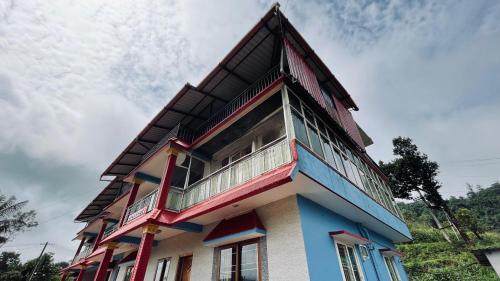 a building with a balcony on top of it at KK Residences in Madikeri