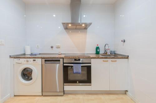 a kitchen with a washing machine and a washer at Taosa - baskeyrentals in Zumaia
