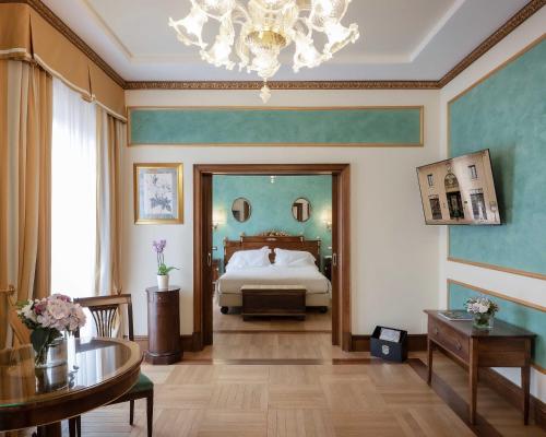 a large bedroom with a bed and a chandelier at Due Torri Hotel in Verona