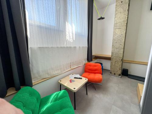 a room with a table and a chair and a window at ROCH800 - industriální aparthotel Klatovy in Klatovy