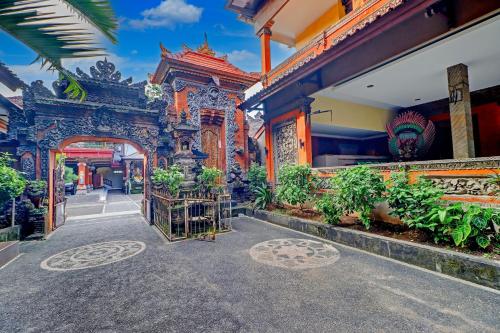 an entrance to a building with plants in it at Collection O Bali near Terminal Ubung formerly Batukaru Garden Hotel in Kesiman