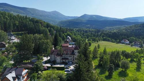 an aerial view of a house in the mountains at Malachit Karpacz SPA Hotel in Karpacz