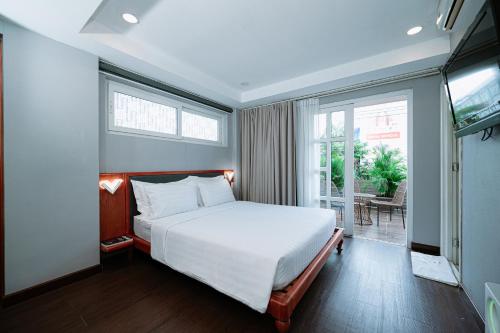 a bedroom with a large bed and a television at PH Hotel Near SECC Phu My Hung in Ho Chi Minh City