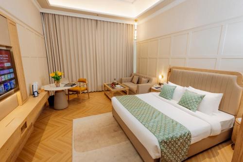 a hotel room with a bed and a couch at The Tivoli New Delhi in New Delhi