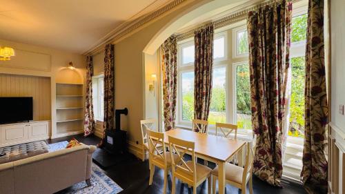 a living room with a table and a couch at Berthlwyd Country House in Conwy