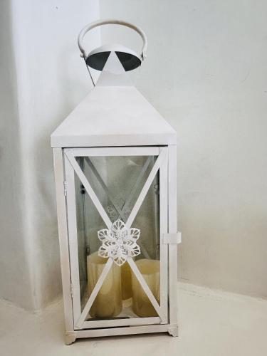 a white lantern with a snowflake inside of it at Arlene Suites in Mesaria