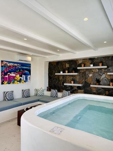 a swimming pool in a living room with a large tub at Arlene Suites in Mesaria