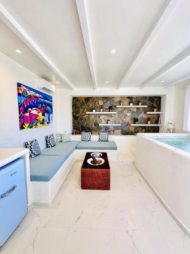 a living room with a pool in the background at Arlene Suites in Mesaria