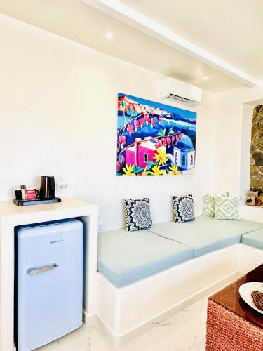 a room with a couch and a painting on the wall at Arlene Suites in Mesaria
