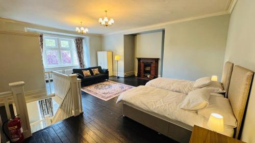 a bedroom with a bed and a living room at Berthlwyd Country House in Conwy